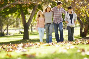 Family with teens walking in the Autumn after attending DBT based family counseling with an Atlanta, GA Therapist in Alpharetta